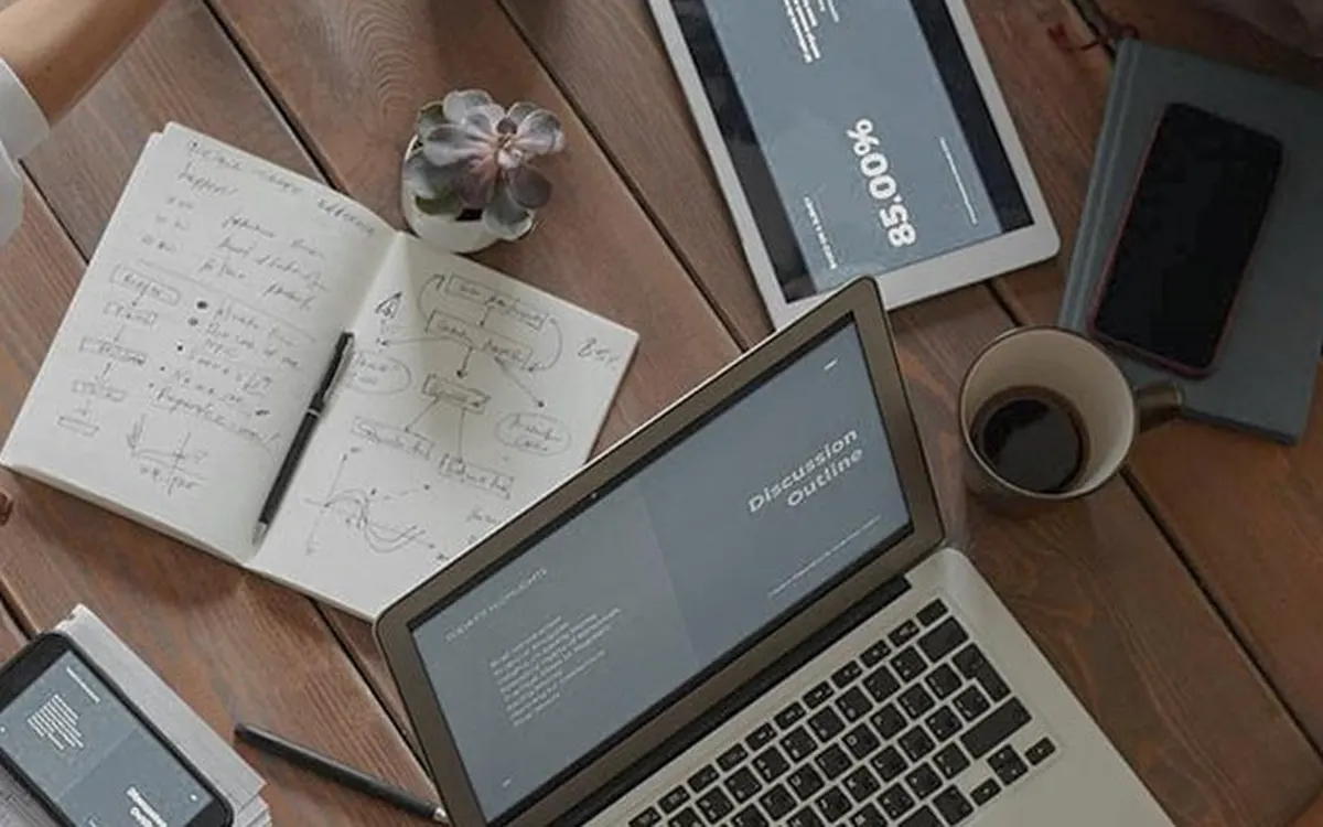 A team with laptops and documents at a work table