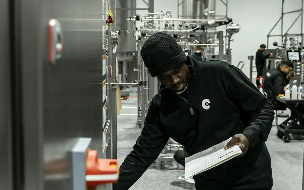 Operator at a control panel in a manufacturing plant